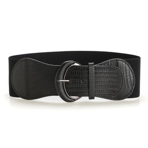 Close-up of women wide elastic belt with silver horseshoe buckle and faux crocodile texture