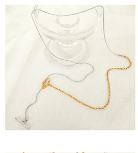 Detail view of two-tone gold and silver snake chain necklace with elegant toggle clasp