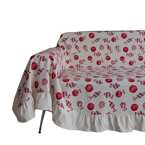 Christmas themed sofa cover with red ornaments, candy canes and ruffled hem design