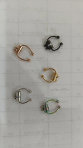 Detail showing five colors of magnetic fake nose rings including gold and rainbow finish