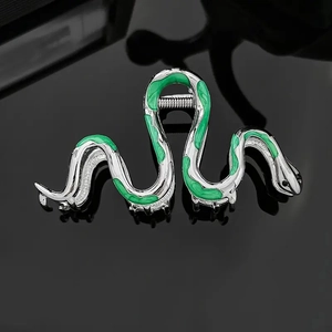Detailed view of silver snake-shaped metal hair claw clip with green enamel finish