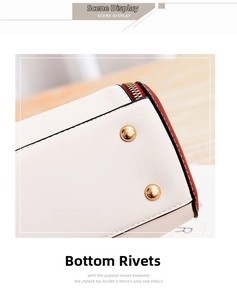 Detail of cream leather handbag base featuring protective gold ball studs and red contrast trim