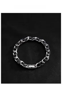 Detail of silver chain bracelet with black leather weave and industrial magnetic clasp