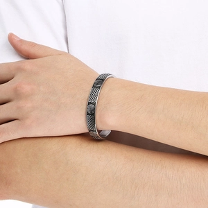 Macro detail of men's Viking Odin shield rune stainless steel open cuff bracelet