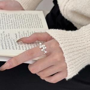 Modern 925 sterling silver beaded ring with cluster design for women on a cozy background