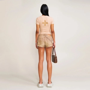 Detailed back view of a slim-fit pink sports tee with a golden cross badge and street style