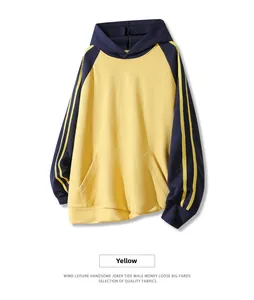 Detail of yellow and navy contrast hoodie with three-stripe sleeves and kangaroo pocket