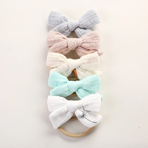 Detailed set of five muslin cotton baby headbands with soft bows and nylon bands