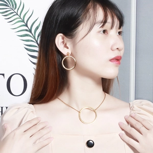 Elegant gold hollow geometric circle necklace and large hoop earrings set on female model
