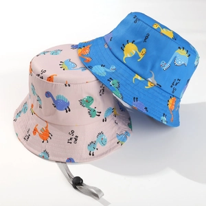 Detail of kids sun hat featuring cute cartoon dinosaurs and adjustable windproof chin strap