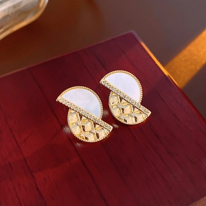 Detailed close-up of 18K gold-plated geometric earrings with white shell inlay and rhinestones
