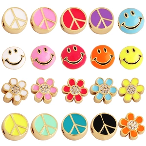 Colorful enamel DIY charms with flowers, smileys, and peace signs in 4x5 grid layout