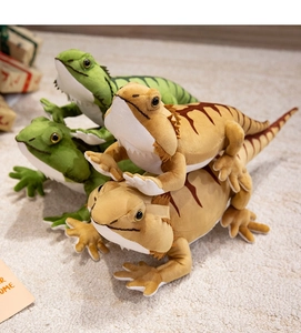 Detailed view of green and brown plush lizard toys with soft texture and striped patterns