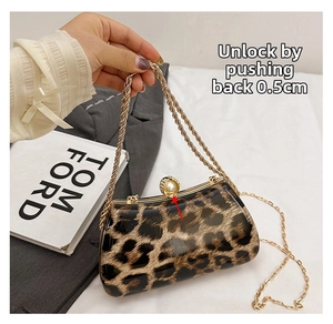 Detail of the vintage leopard print box bag showing the pearl lock and gold chain strap
