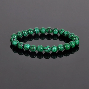 Natural 8mm malachite beaded bracelet with green striped stones on reflective background