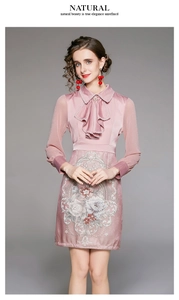 Detail of elegant lapel ruffle neckline and delicate floral embroidery on purple dress