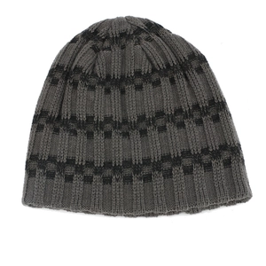Detailed close-up of dark grey striped knit beanie with vertical ribbed texture