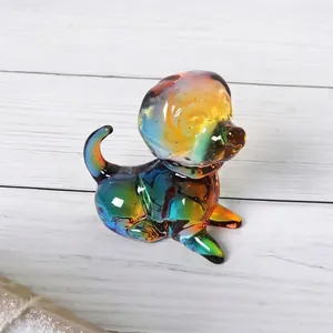Close-up of rainbow glass dog figurine with vibrant gradient colors on white wood