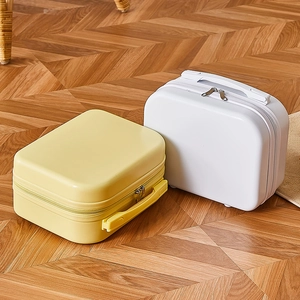 Mini 14 inch hardshell suitcase and makeup cases in yellow and white on wood floor