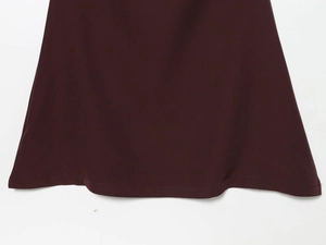 Close-up of the wine red dress hemline showing high-quality stitching and smooth fabric