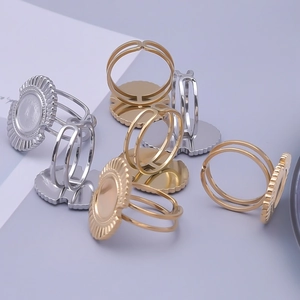 Close-up of adjustable stainless steel ring blanks with sunburst textured base for DIY