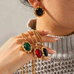 Close-up of French vintage gemstone necklaces and earrings with gold twisted borders