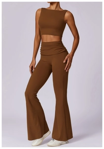 Detail view of chocolate brown high-waisted flared yoga pants and cropped sports tank top