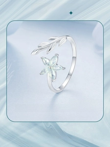 Close-up of S925 sterling silver stamp on open floral ring with green petals