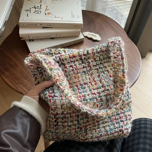 Close-up of colorful tweed woven shoulder bag showing rich texture and knit details