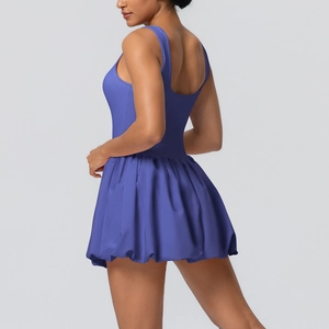 Detail view of navy blue backless tennis dress featuring a stylish bubble skirt silhouette