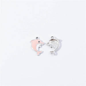 Detail of pink enamel and silver finish dolphin charms for DIY jewelry making