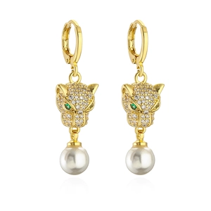 Gold leopard head earrings with zircon and green eyes featuring a large pearl drop