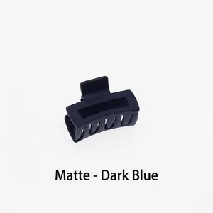 Detail shot of the matte dark blue square hair claw clip showing frosted texture