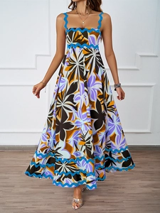 Detail of vibrant palm print maxi dress with blue scalloped embroidery and high waist design