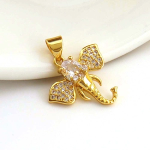 Macro shot of 18k gold plated elephant head pendant with sparkling zircon inlay details