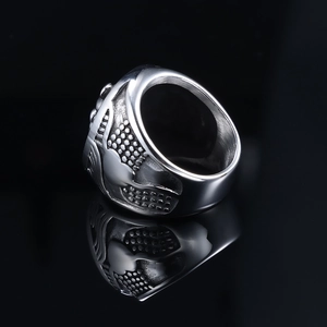 Detail of vintage lion head ring with embossed dot matrix and polished silver finish