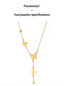 Macro detail of 18K gold butterfly Y-shaped necklace with frosted pendants and beads