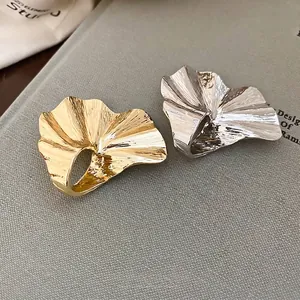 Artistic crumpled petal metal rings in gold and silver finish with textured surface