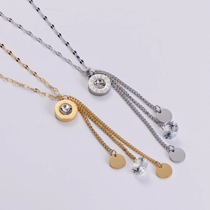 Detail of Roman numeral tassel necklaces in gold and silver with sparkling zircon