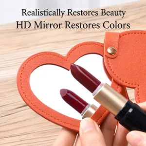 Portable orange leather heart-shaped folding makeup mirror with key ring attachment