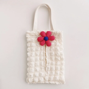 Close-up of white popcorn fabric tissue holder with a vibrant 3D flower decoration