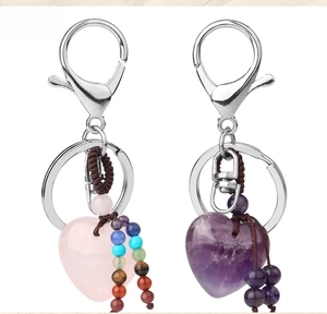 Detail of heart-shaped rose quartz and amethyst keychains with colorful bead charms