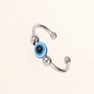 Macro shot of silver horseshoe ring featuring blue Evil Eye beads for anxiety relief