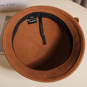 Detail view of wool fisherman hat interior featuring adjustable string and 100% wool label