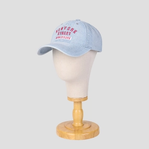 Light blue washed denim baseball cap with red New York embroidery on grey background