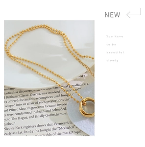 Detail of 18K gold-plated double-layer necklace featuring three interlocking rings