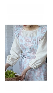 Detail of blue floral French cotton apron with ruffles and breathable light fabric