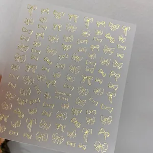 Macro shot of gold bowknot nail art stickers YO-044 with detailed bronzing texture