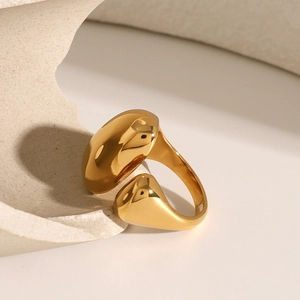 Artistic display of gold minimalist open ring with smooth polished metallic finish