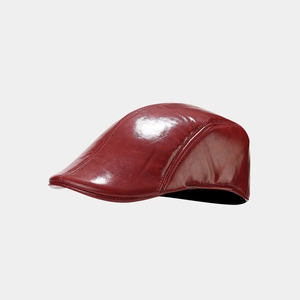 Detail of burgundy PU leather beret showing glossy finish and precise stitching